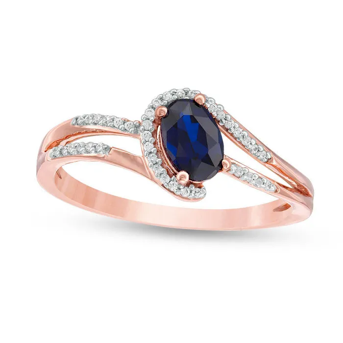 Oval LabCreated Blue Sapphire and 007 CT TW Diamond Swirling Bypass Split Shank Promise Ring in Solid 10K Rose Gold Goldia Rings Oval LabCreated Blue Sapphire and 007 CT TW Diamond Swirling Bypass Split Shank Promise Ring in Solid 10K Rose Gold Goldia Rings