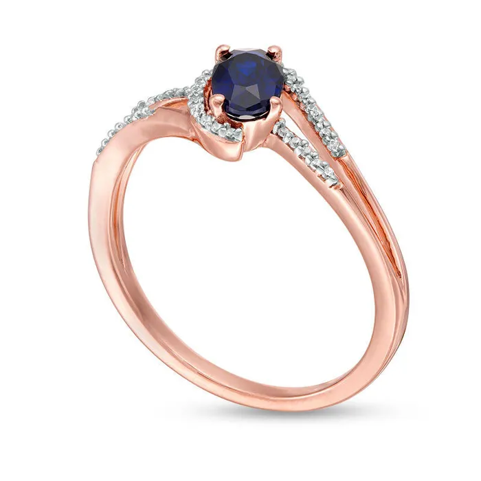Oval LabCreated Blue Sapphire and 007 CT TW Diamond Swirling Bypass Split Shank Promise Ring in Solid 10K Rose Gold Goldia Rings